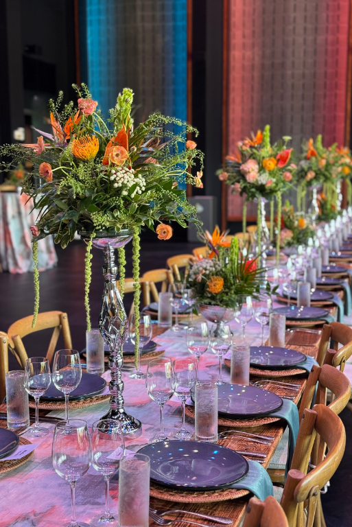Long banquet table with tall floral centerpieces for a seated dinner
