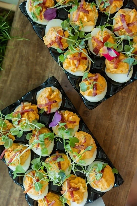 Deviled eggs with bacon and microgreens on a brunch buffet