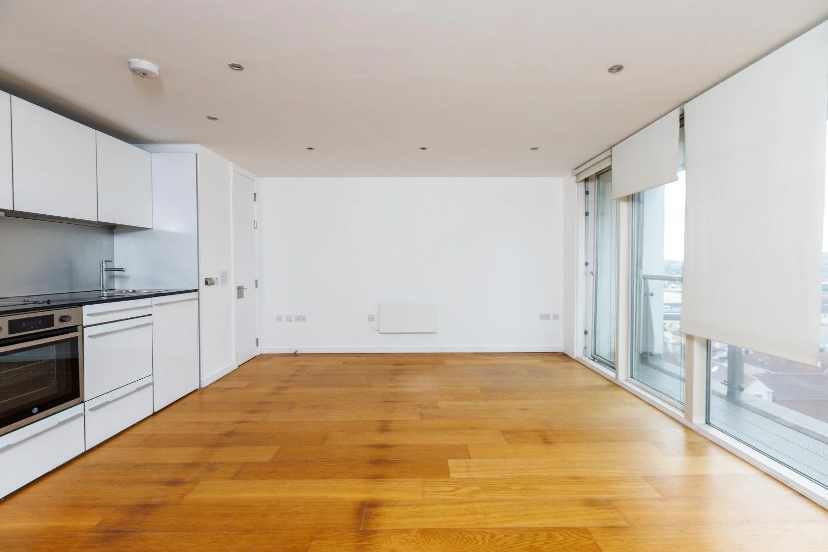 Open-plan lounge & kitchen staging — before