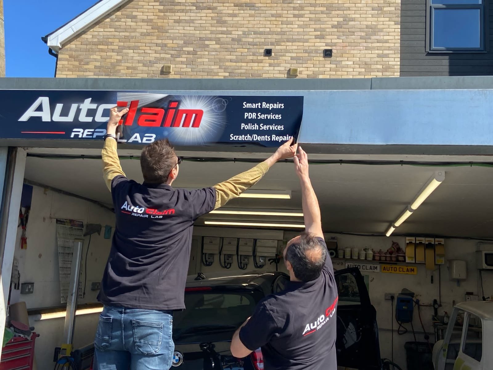 Auto Claim Repair Lab Installing New Garage Logo Sign