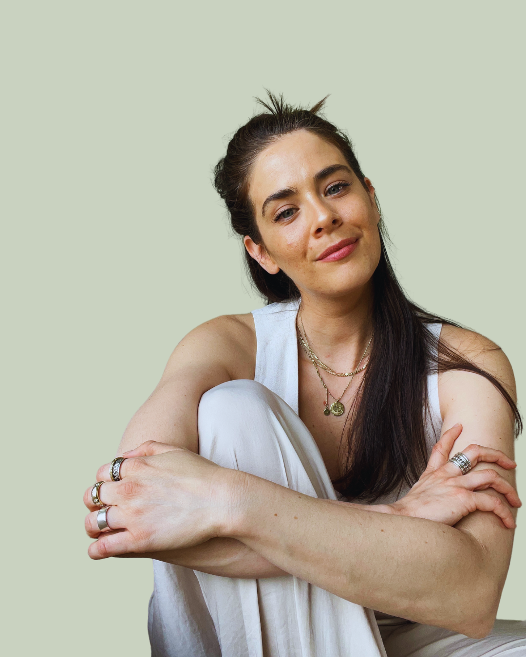 Kate McQuilken seated with her arms folded over her knee