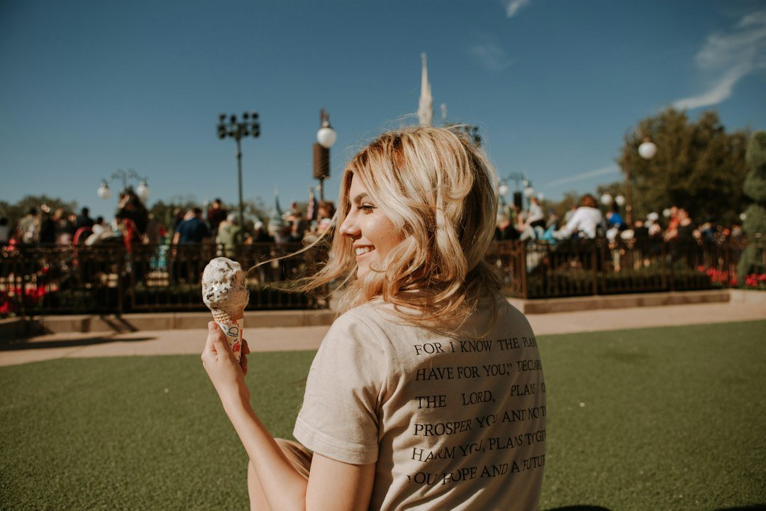 Smiling woman holding out an ice cream cone