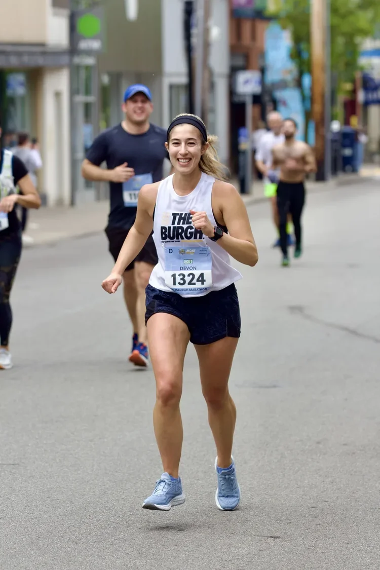 Devon running the Pittsburgh Marathon, smiling