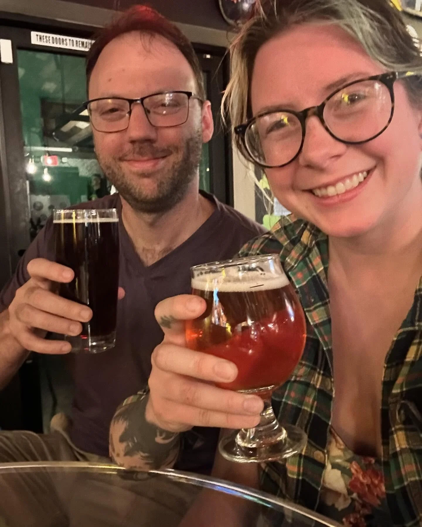 Asia and Eric enjoying a brewery while traveling