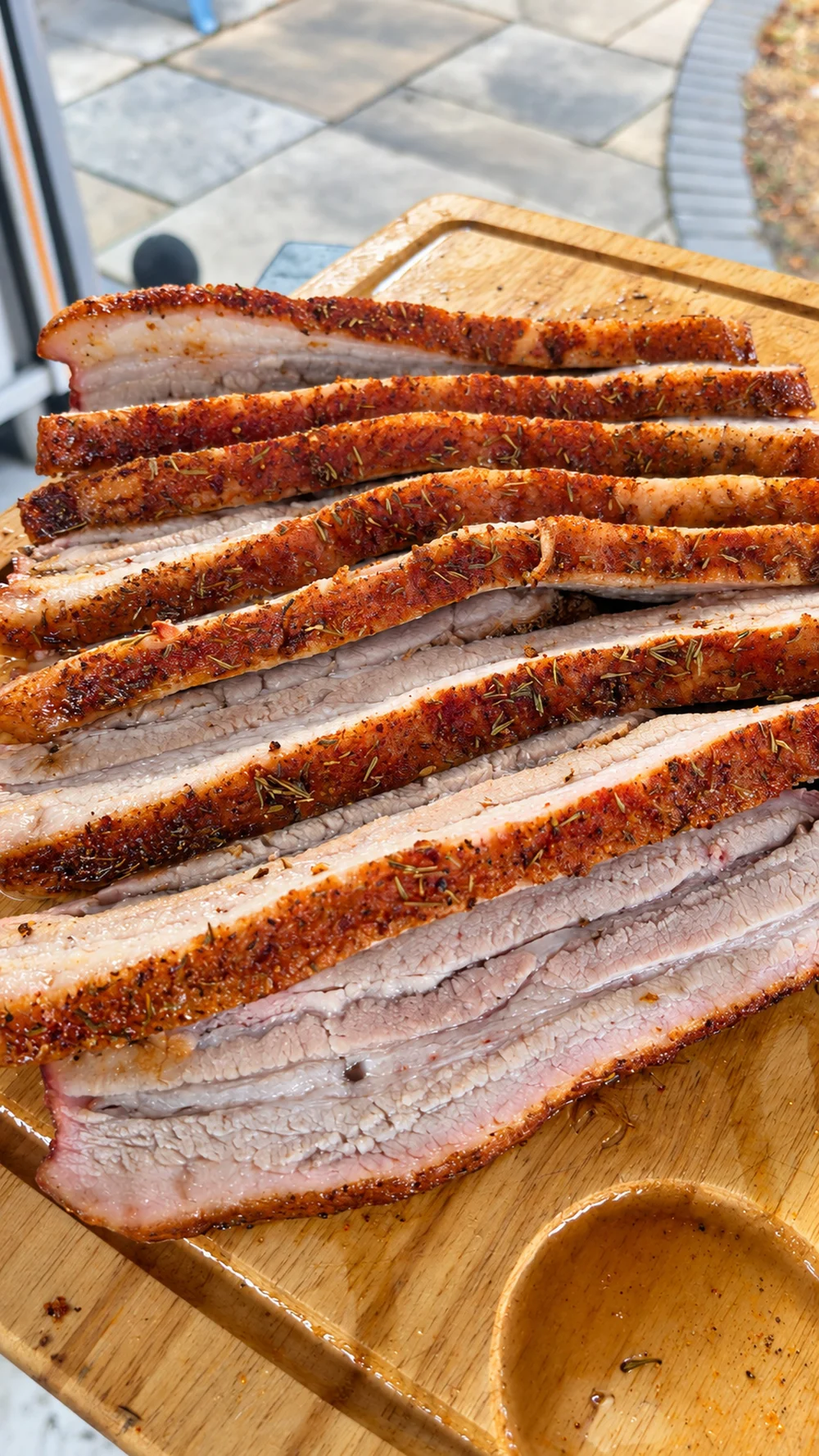 Close-up of sliced pork belly with crisp seasoned edges