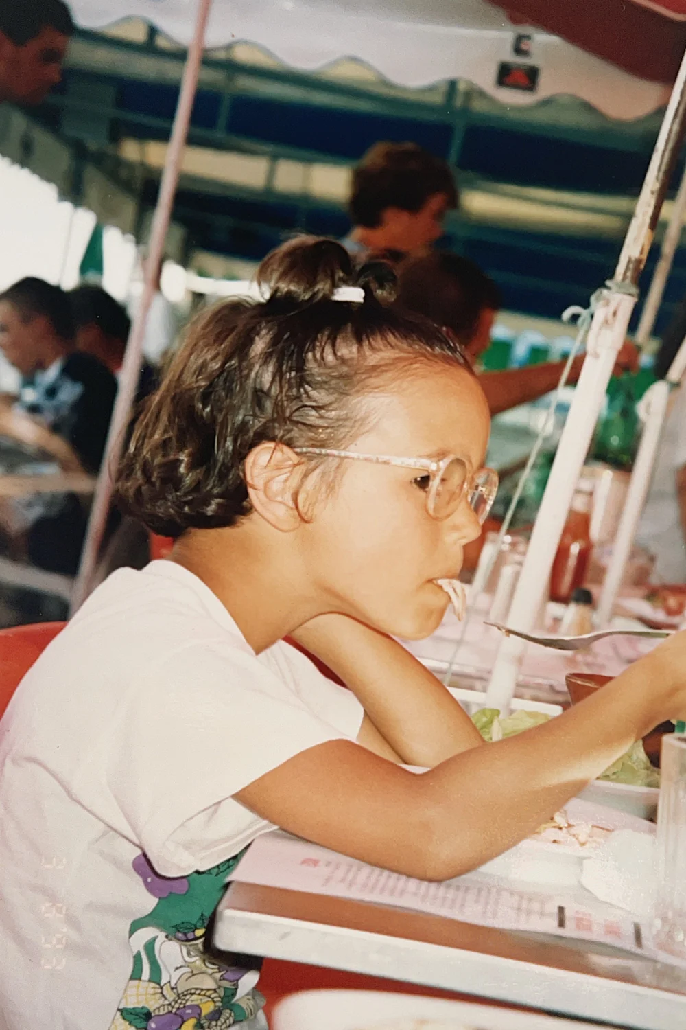 Sofia as a child, drawing at a table