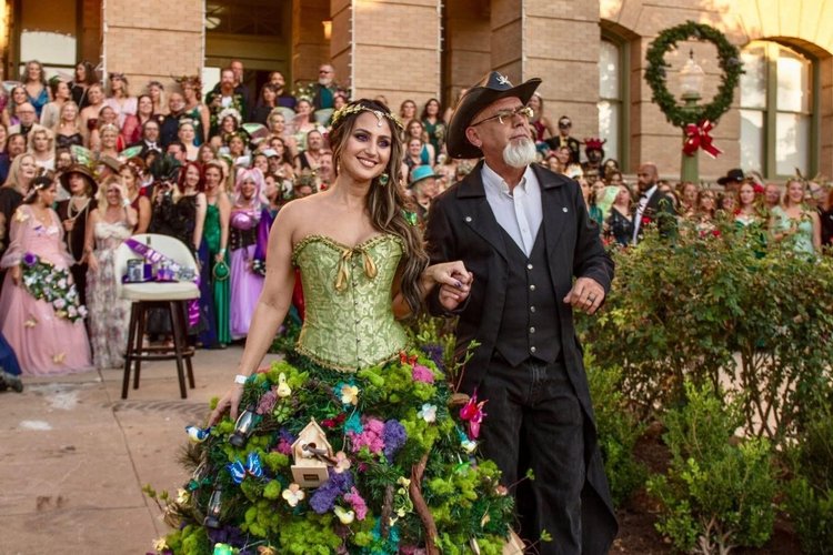 A guest in a colorful floral gown at the courthouse gathering