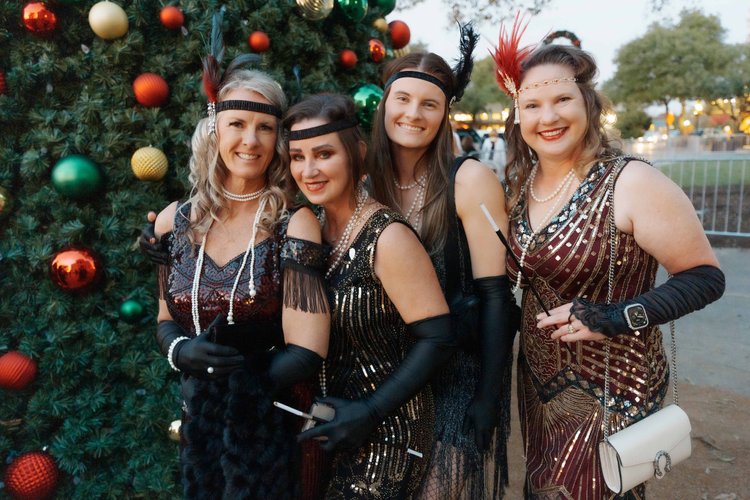 Friends dressed up together at a past Ballgown Square Crawl