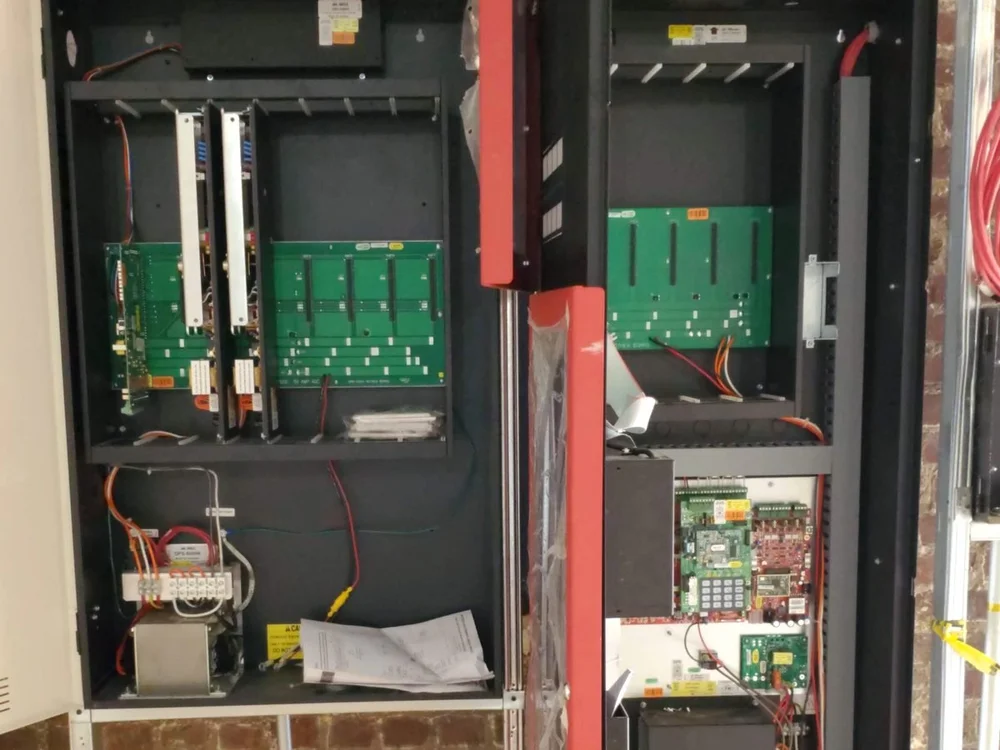 Open fire alarm panel with field wiring landed