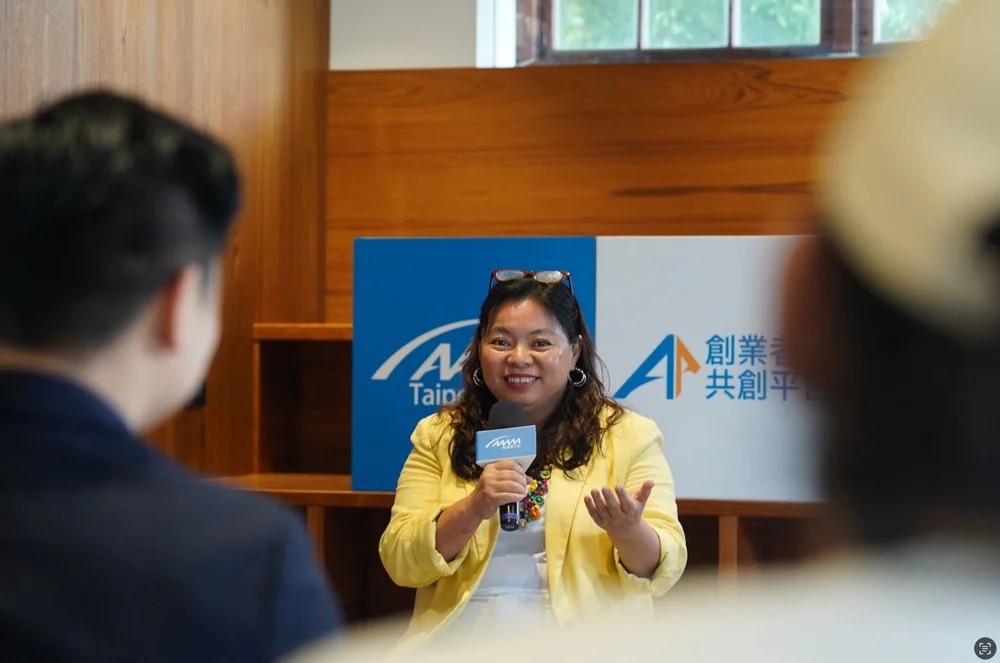 Jenny Hsu speaking to an engaged room moments after stepping off stage