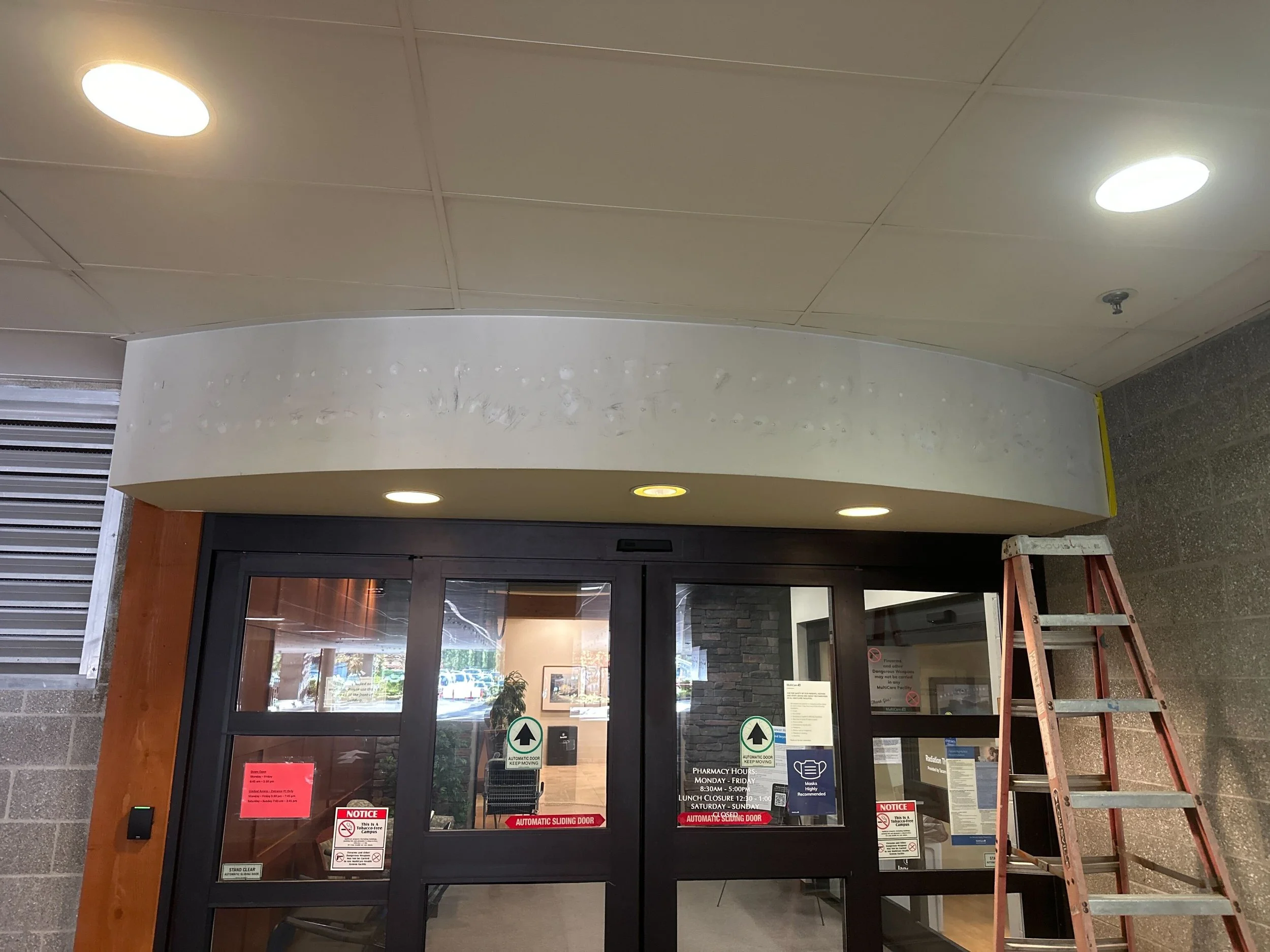 Canopy soffit with legacy letters removed and surface prepped for the new illuminated sign install at MultiCare Gig Harbor