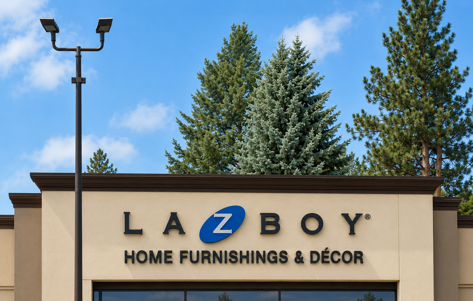 New face-lit La-Z-Boy channel-letter wall sign installed across the storefront at the Spokane Furniture Galleries main entrance, fabricated and installed by Plumb Signs