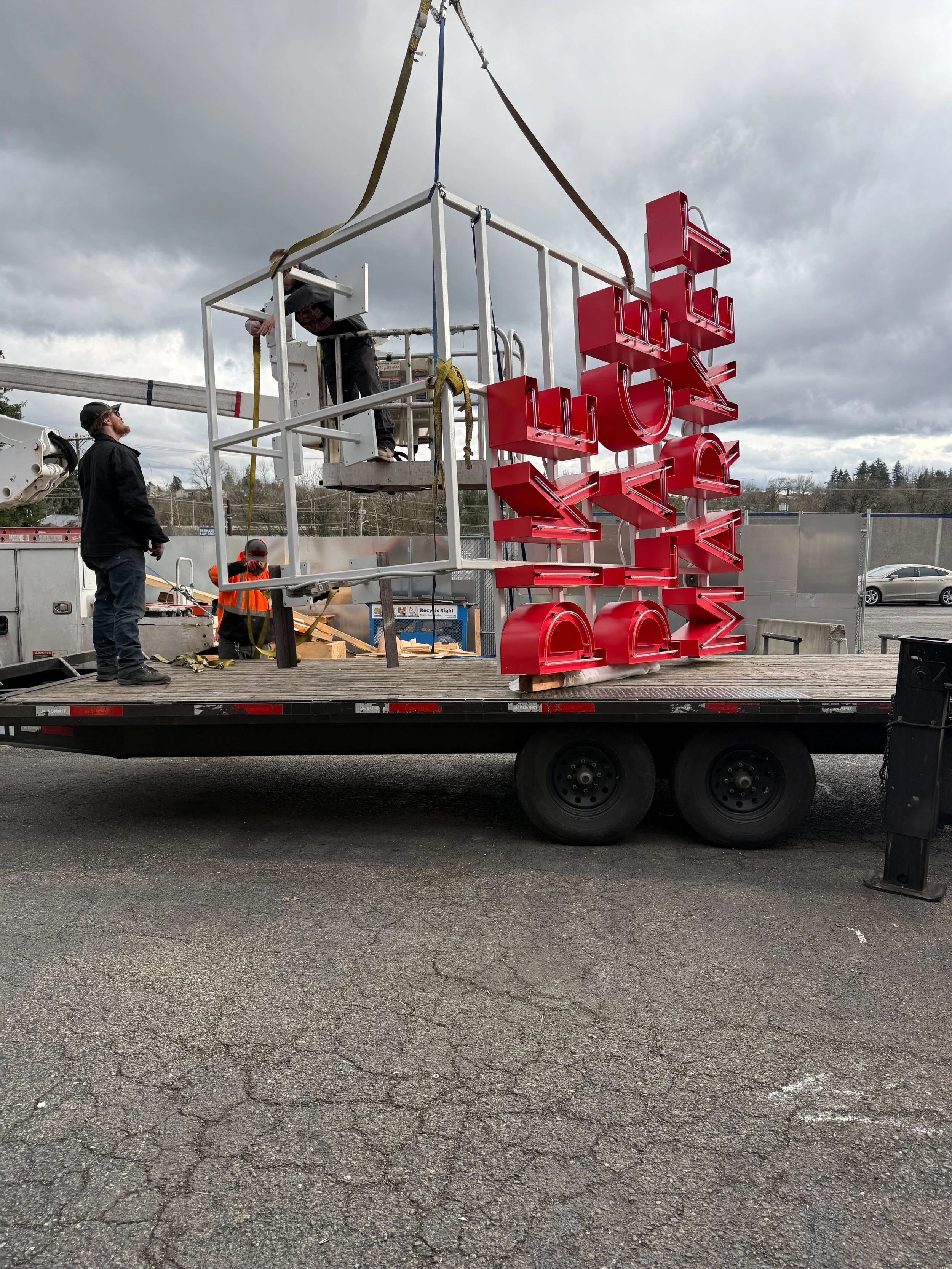 Pike Place Market sign assembly staged for load-in and lift