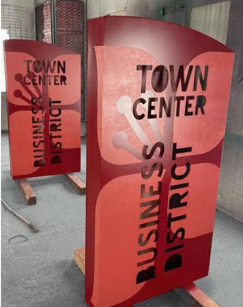 Town Place University Place monolith signs receiving custom paint finishes in the Plumb Signs paint booth