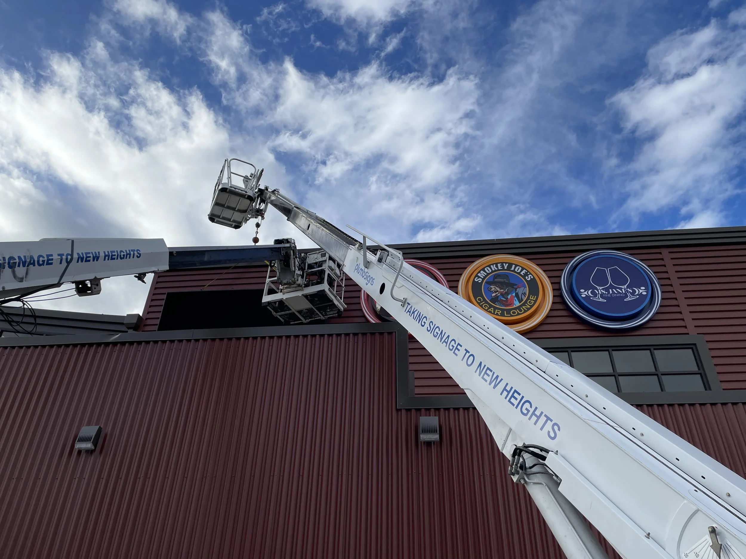 Plumb Signs installation crew mounting exterior signage Fife WA