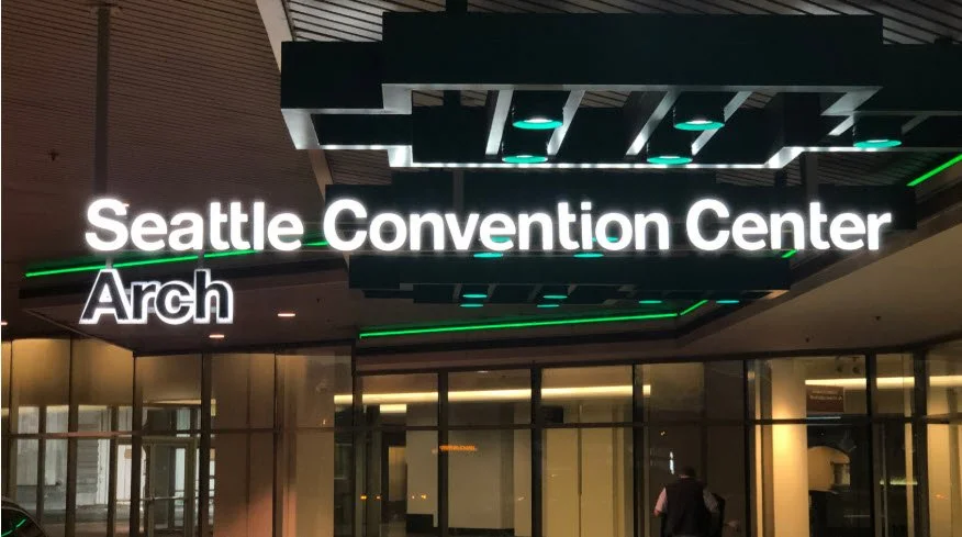 Seattle Convention Center exterior signage with illuminated green branding