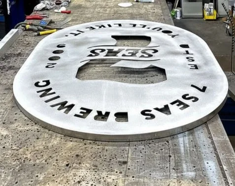 Routed aluminum face with push-thru lettering fabrication at Plumb Signs Tacoma