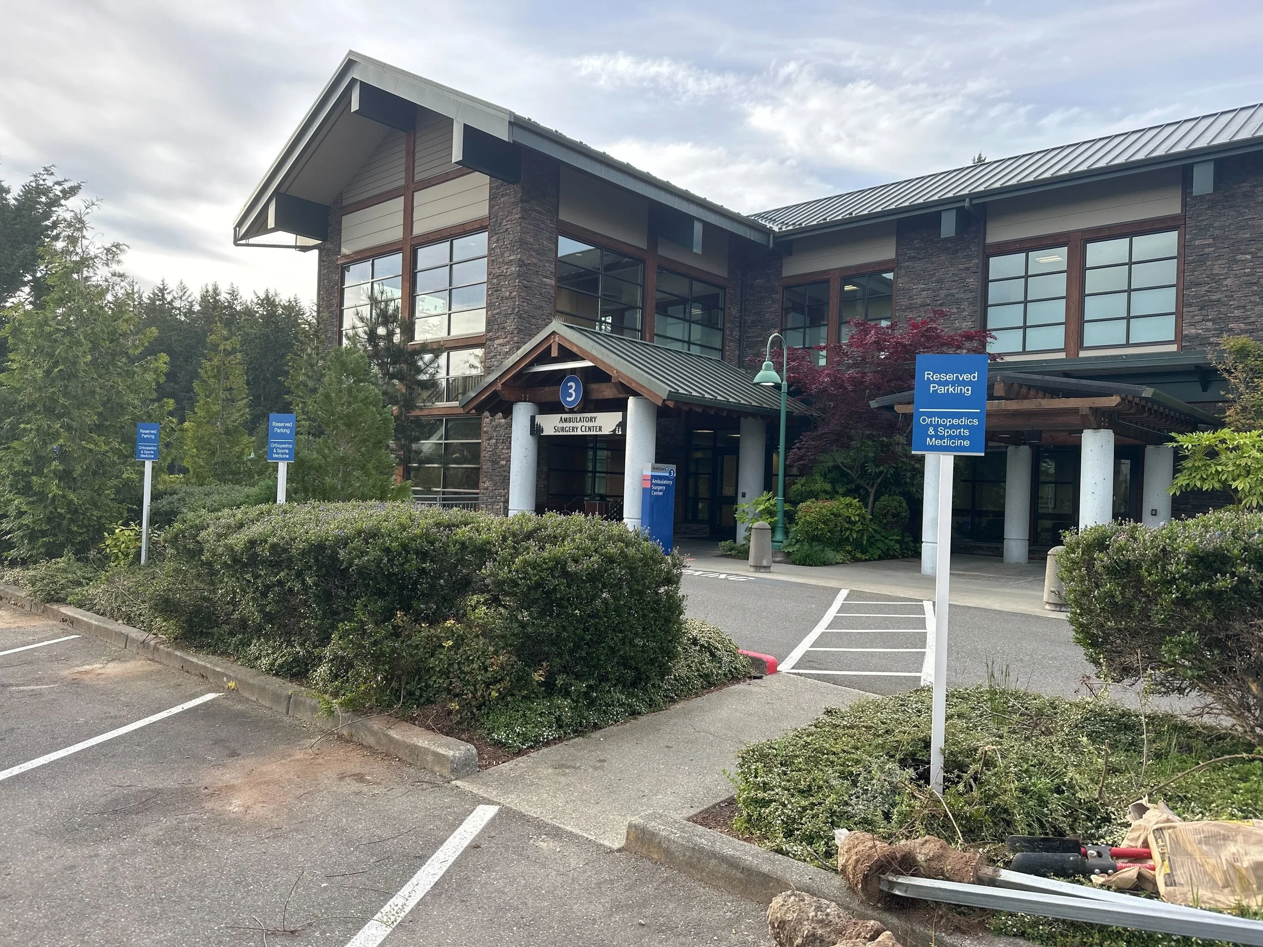 MultiCare Gig Harbor Ambulatory Surgery Center exterior with legacy reserved-parking signage before the campus rebrand