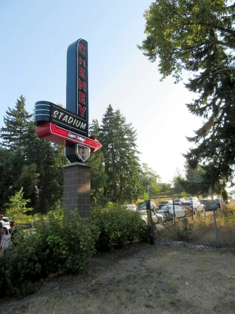 Vertical neon-style stadium sign at night