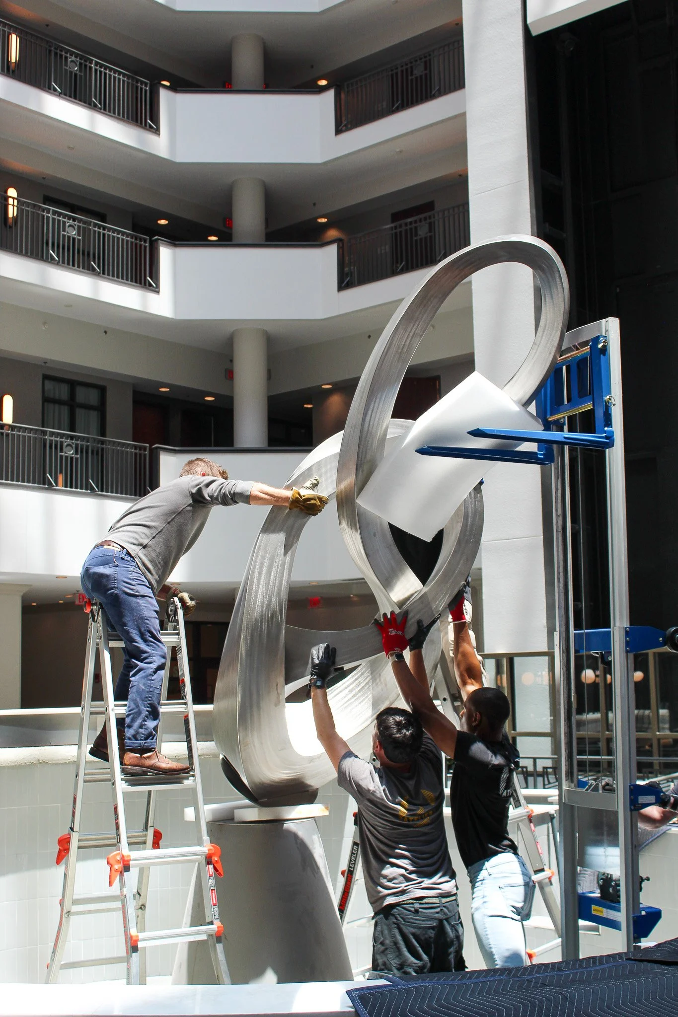 Atelier 4 team installing artwork on-site