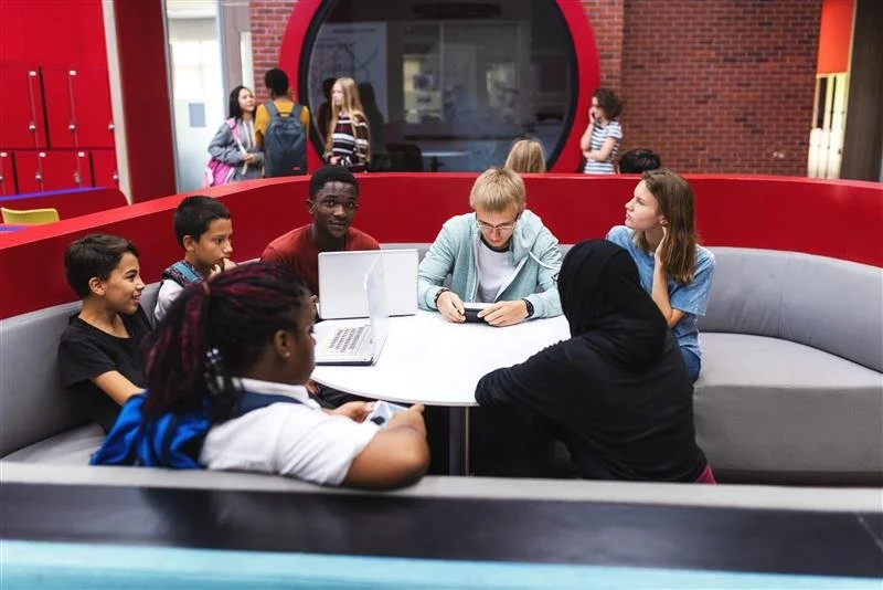 Youth leaders collaborating in classroom