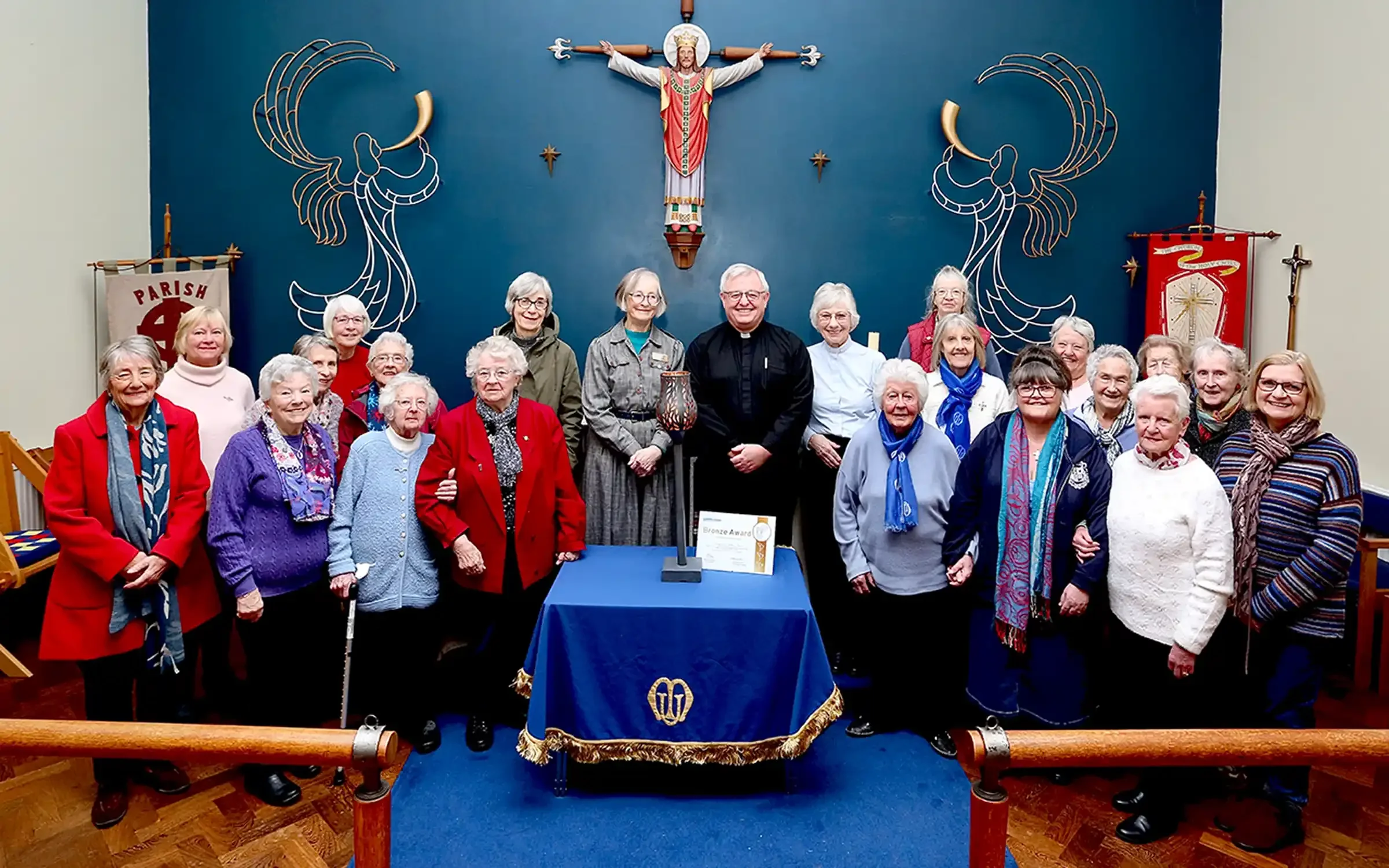 Mothers' Union members with Rev'd Hywel Griffiths after the torch handover