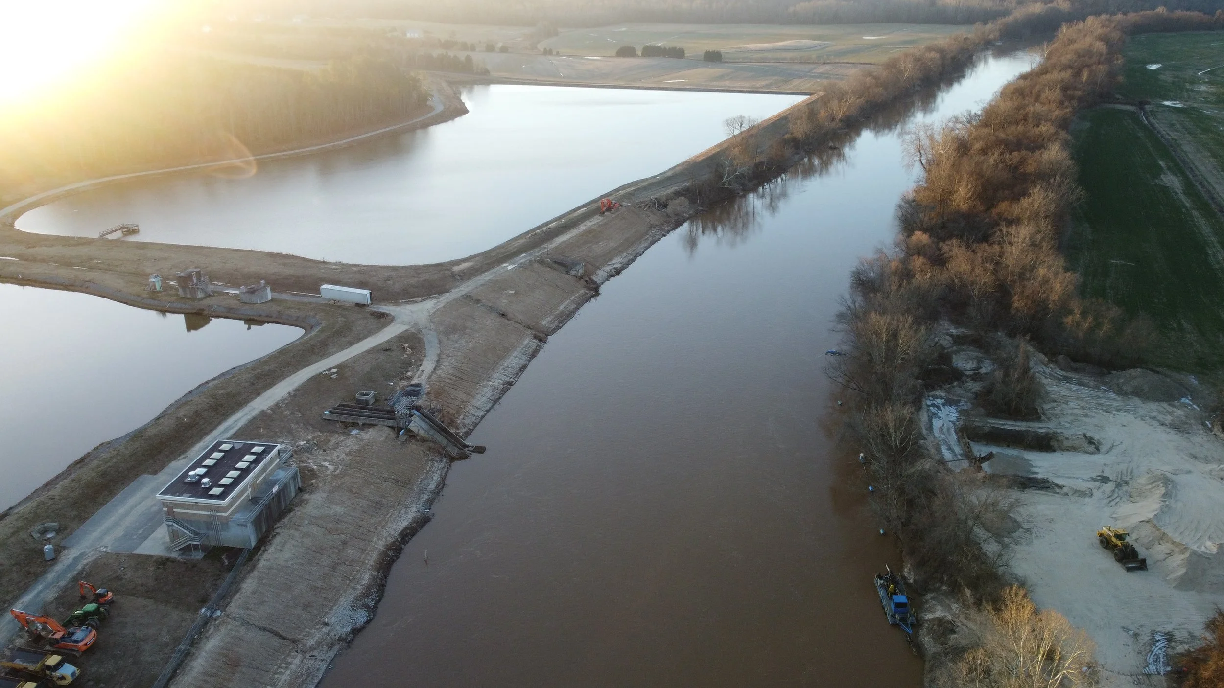 Aerial view of earthworks and access roads beside water basins