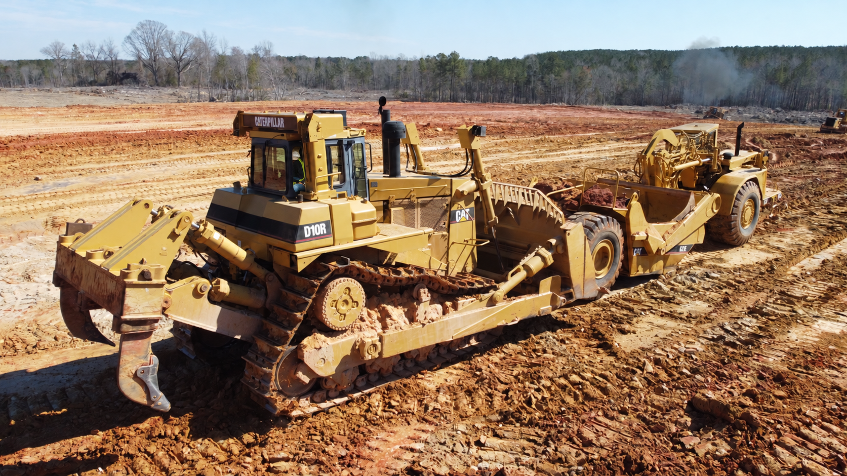 Caterpillar bulldozer and scraper at an Idlewild earthworks project