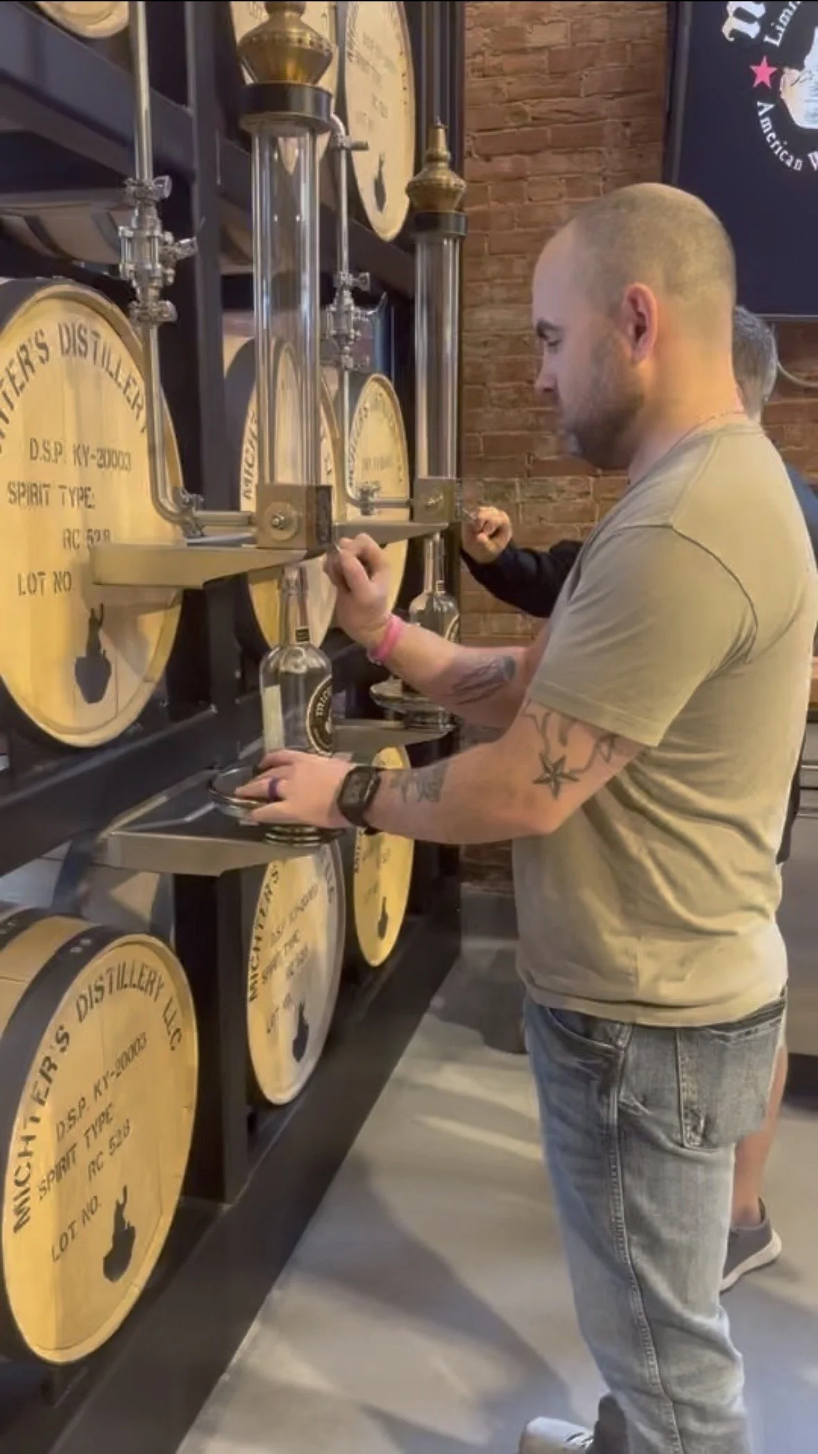Seth learning about whiskey production during a Kentucky distillery experience.