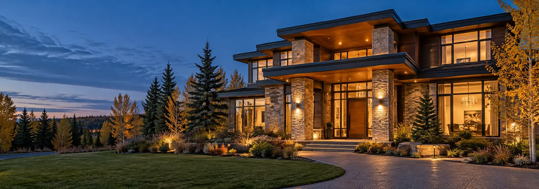 Large contemporary estate residence illuminated at dusk