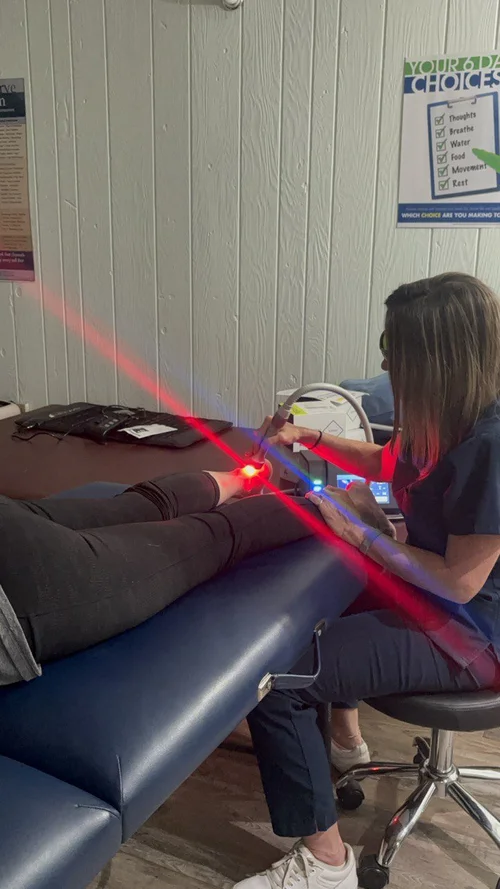 Red therapy beam applied to the ankle