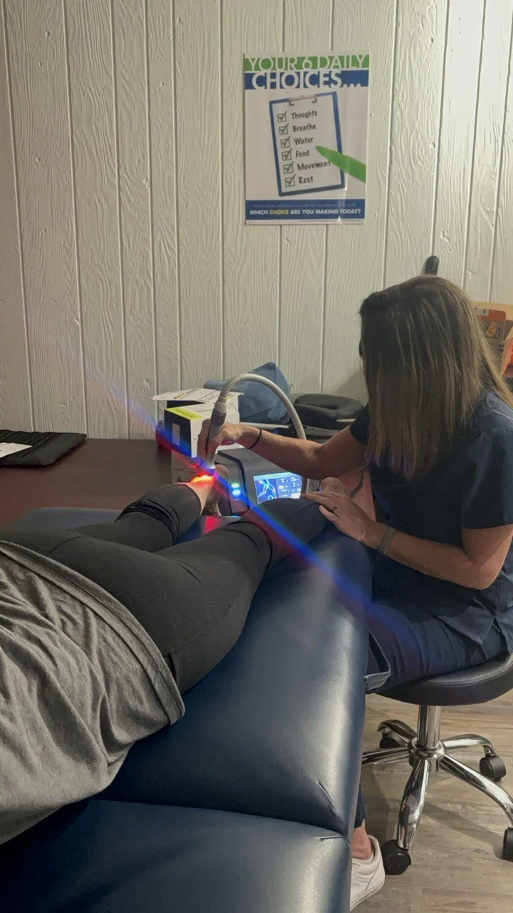 Practitioner treating a patient's ankle with the LuminaHeal Class IV laser