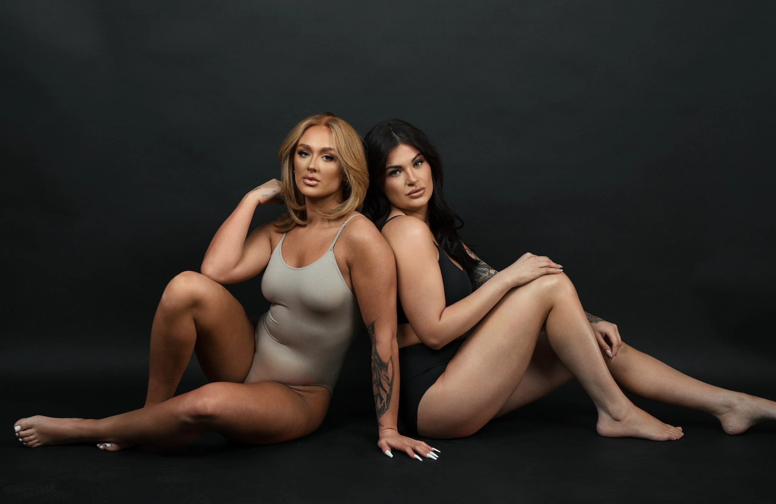 Two glowing custom spray tan clients, never orange, The Glow Haven