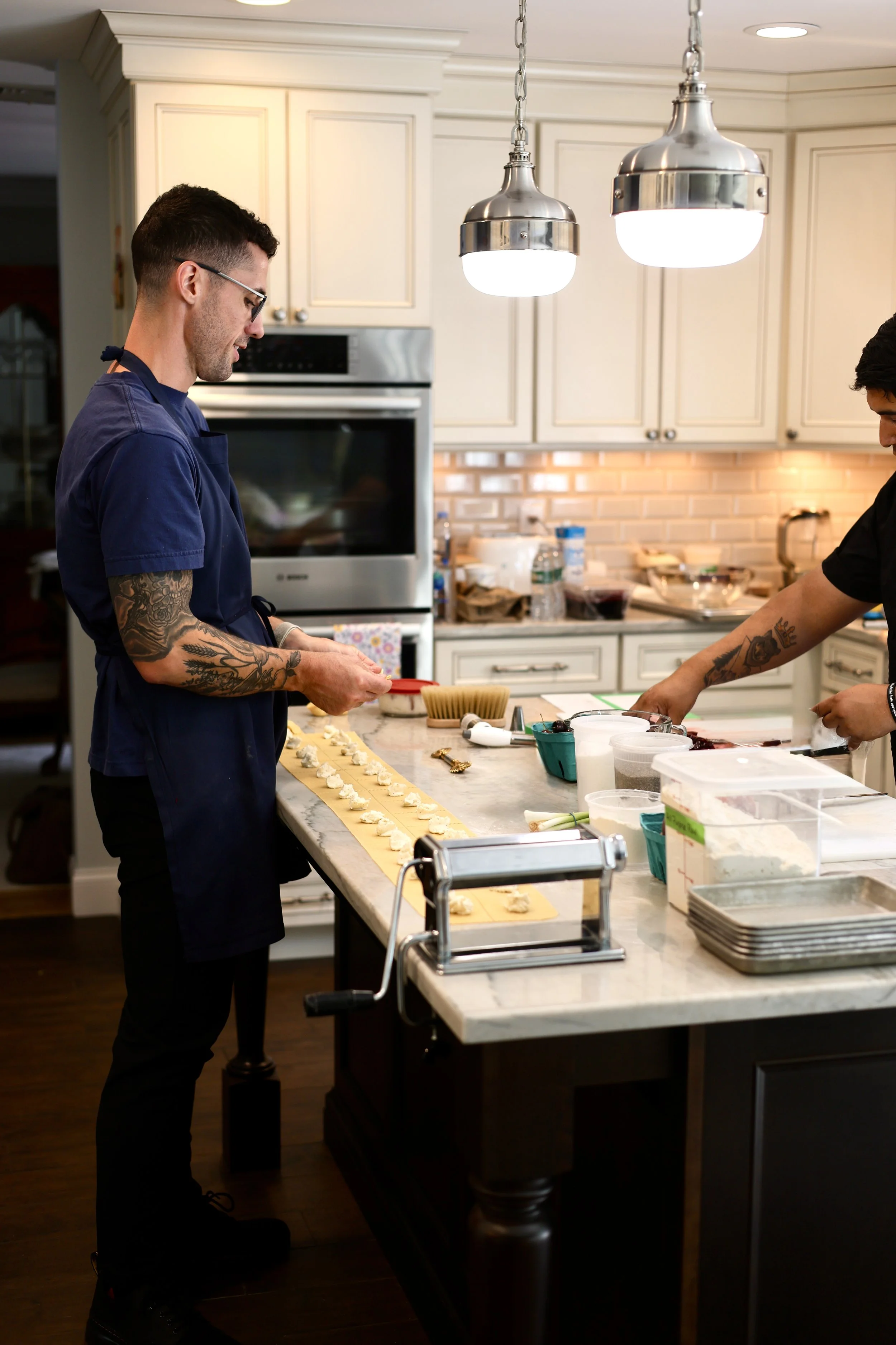 Chef and staff prepping fresh pasta before a private dinner