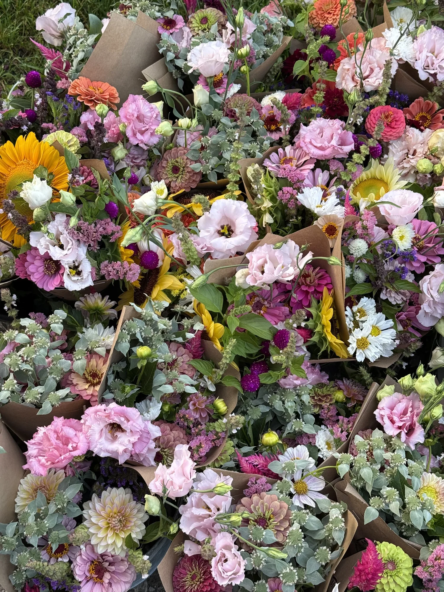 Mixed farm-grown bouquets wrapped in kraft paper
