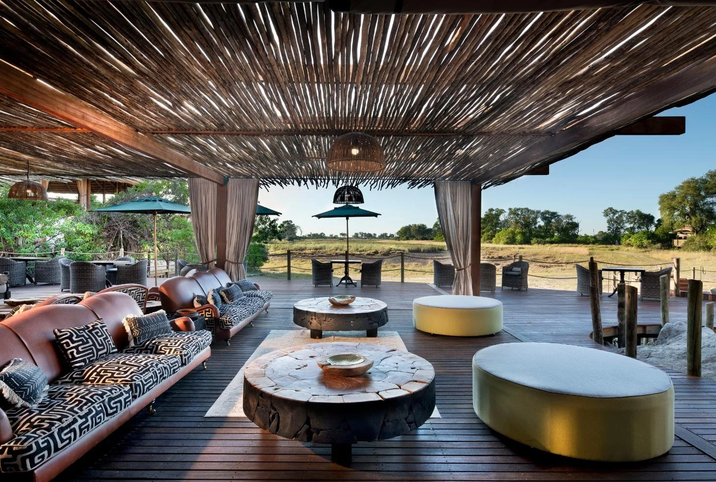 Shaded lounge deck at Atzaro Okavango Camp with Delta views, Botswana luxury safari