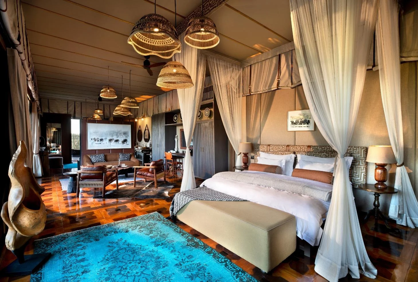 Atzaro Okavango Camp luxury tented suite with canopy bed and turquoise rug, Okavango Delta Botswana