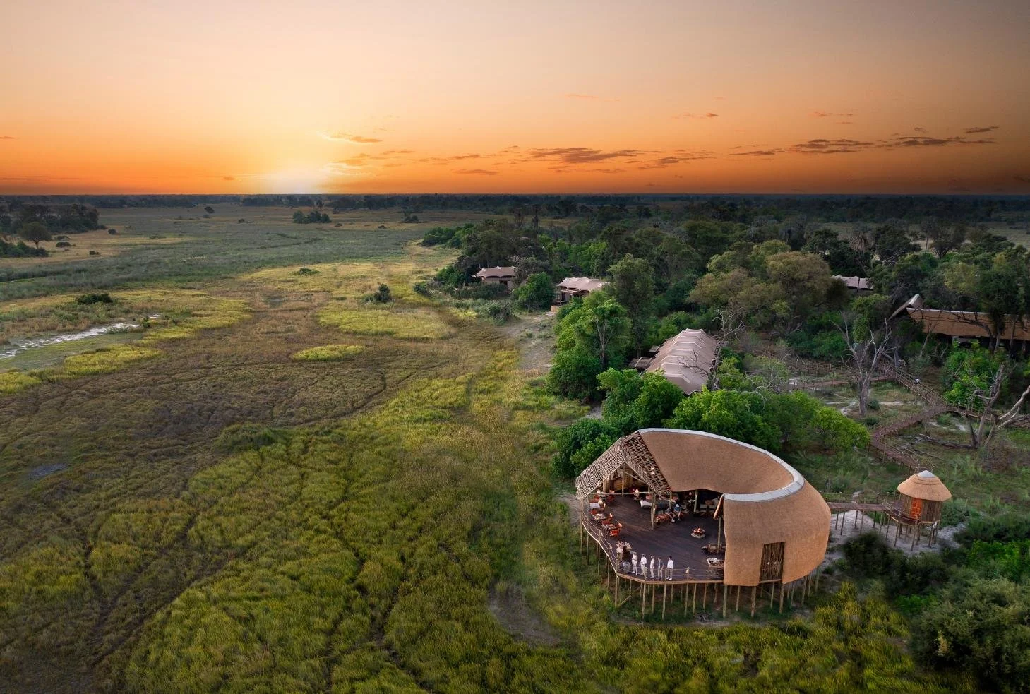 Sunset over Atzaro Okavango Camp main deck facing the Okavango Delta grasslands, Botswana