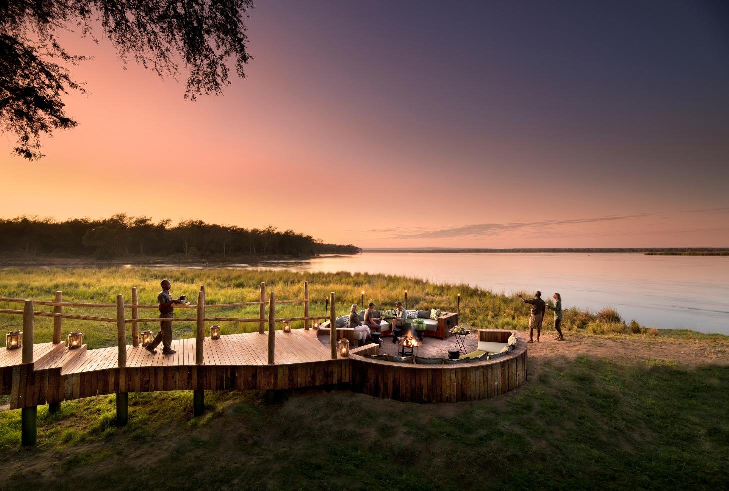 Sunset on Lolebezi riverside deck and sunken firepit on the Zambezi, Lower Zambezi National Park, Zambia