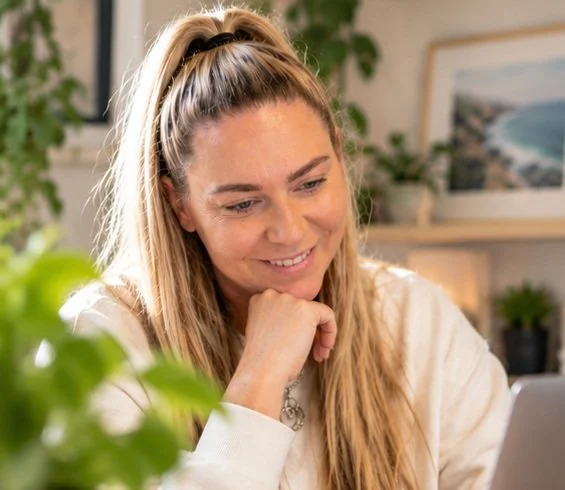 Kirsty Skeates, founder of PetBizAI, smiling at her desk