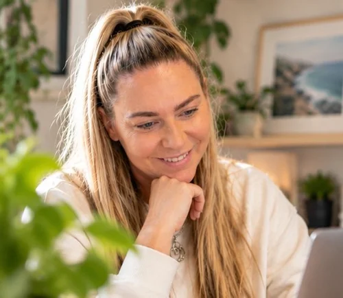 Kirsty Skeates, founder of PetBizAI, smiling at her desk