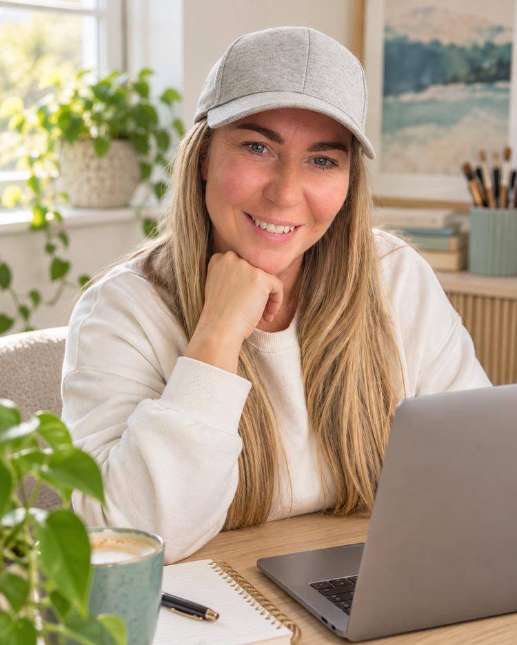 Kirsty Skeates, founder of PetBizAI, smiling at her desk with a laptop