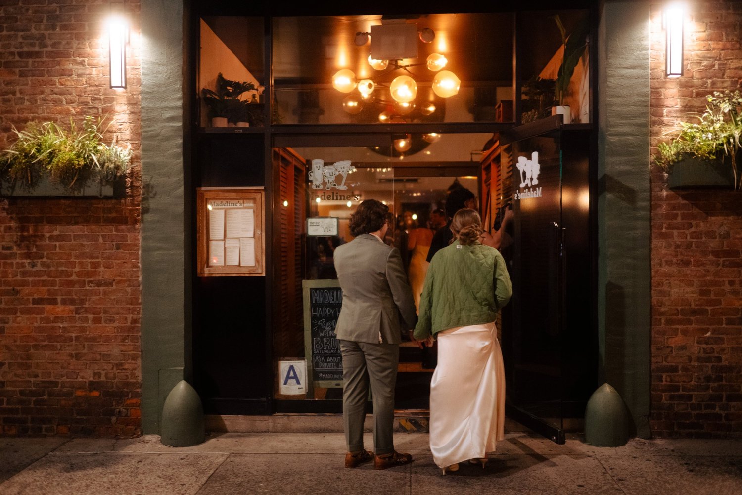 Bride and groom at the door of the after-party