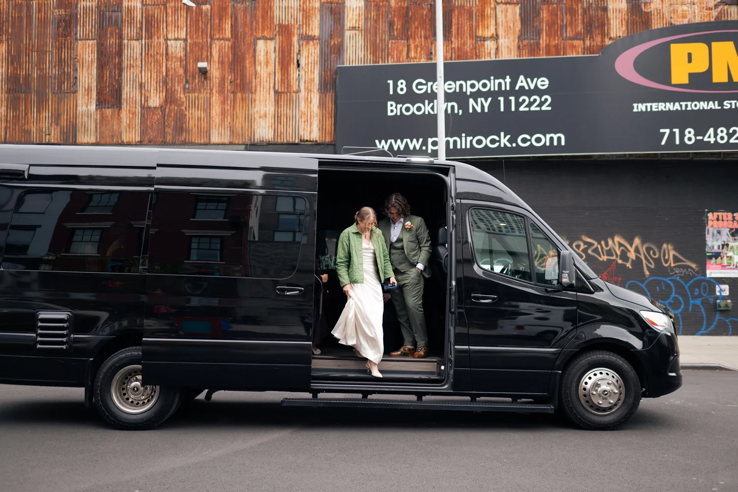 Bride and groom step out of a black van on Greenpoint Avenue