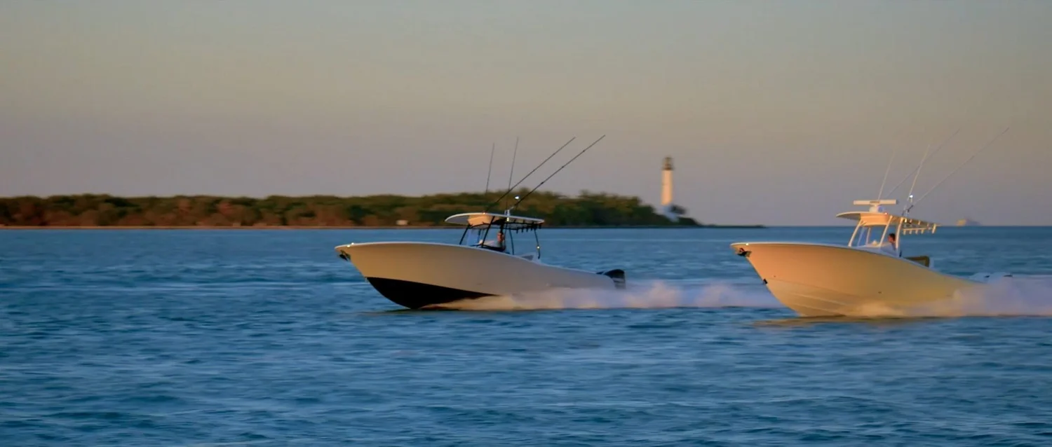 Two Mag Bay Yachts 33 boats running near the Cape Florida Lighthouse
