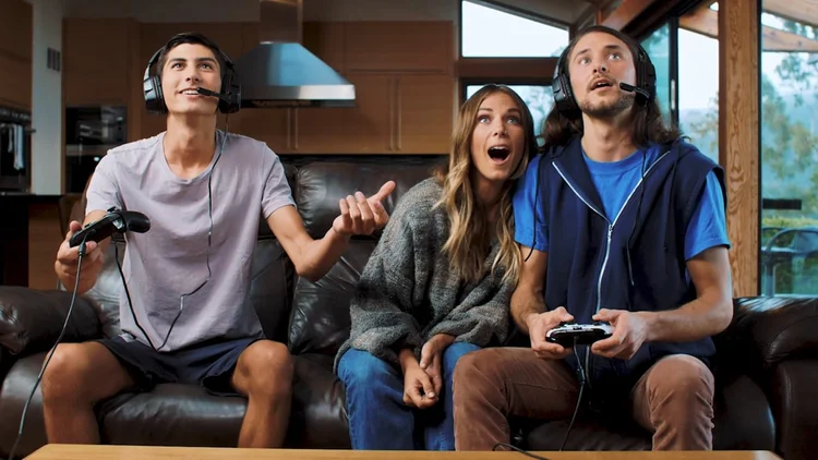 Three gamers on a couch in headsets, from a Hilo Motion Pictures Amazon product video for PDP Gaming