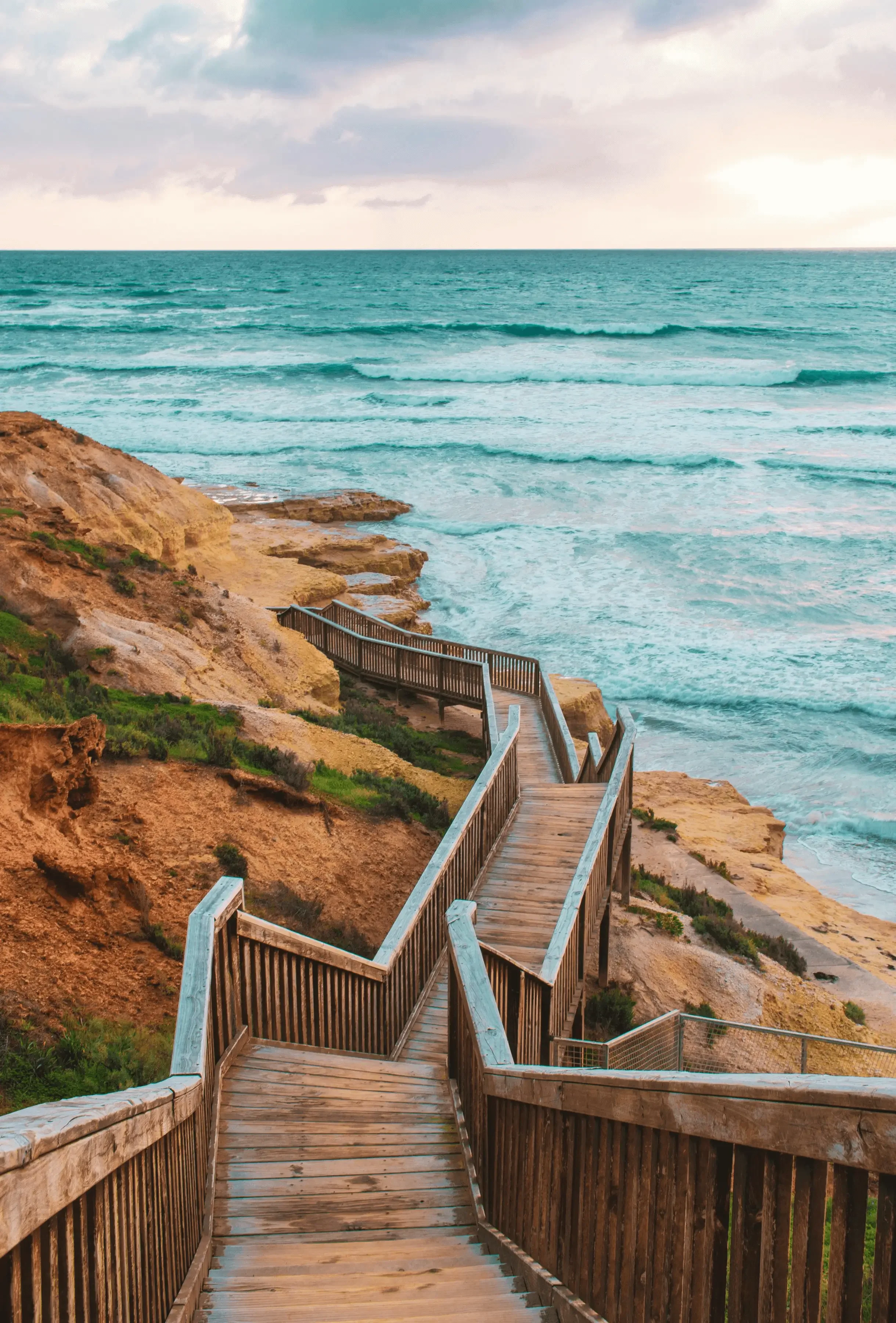 A boardwalk hugging the cliffs overlooking the ocean
