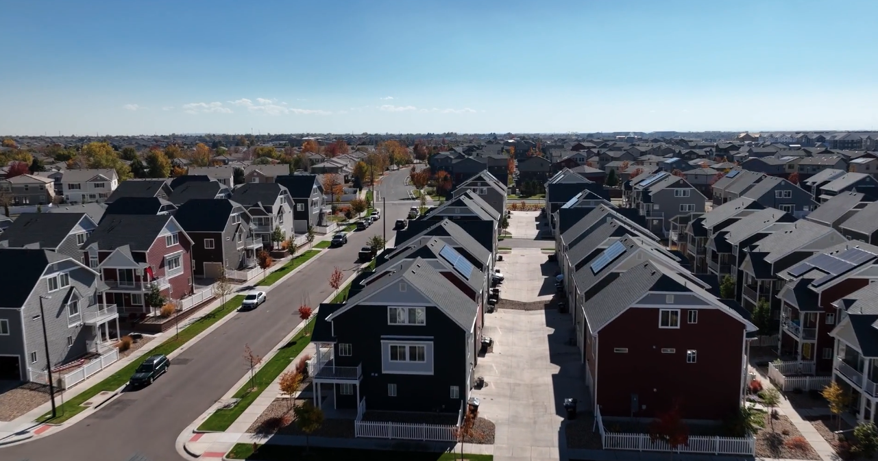 Aerial view of a multifamily neighborhood with homes, streets and shared site improvements