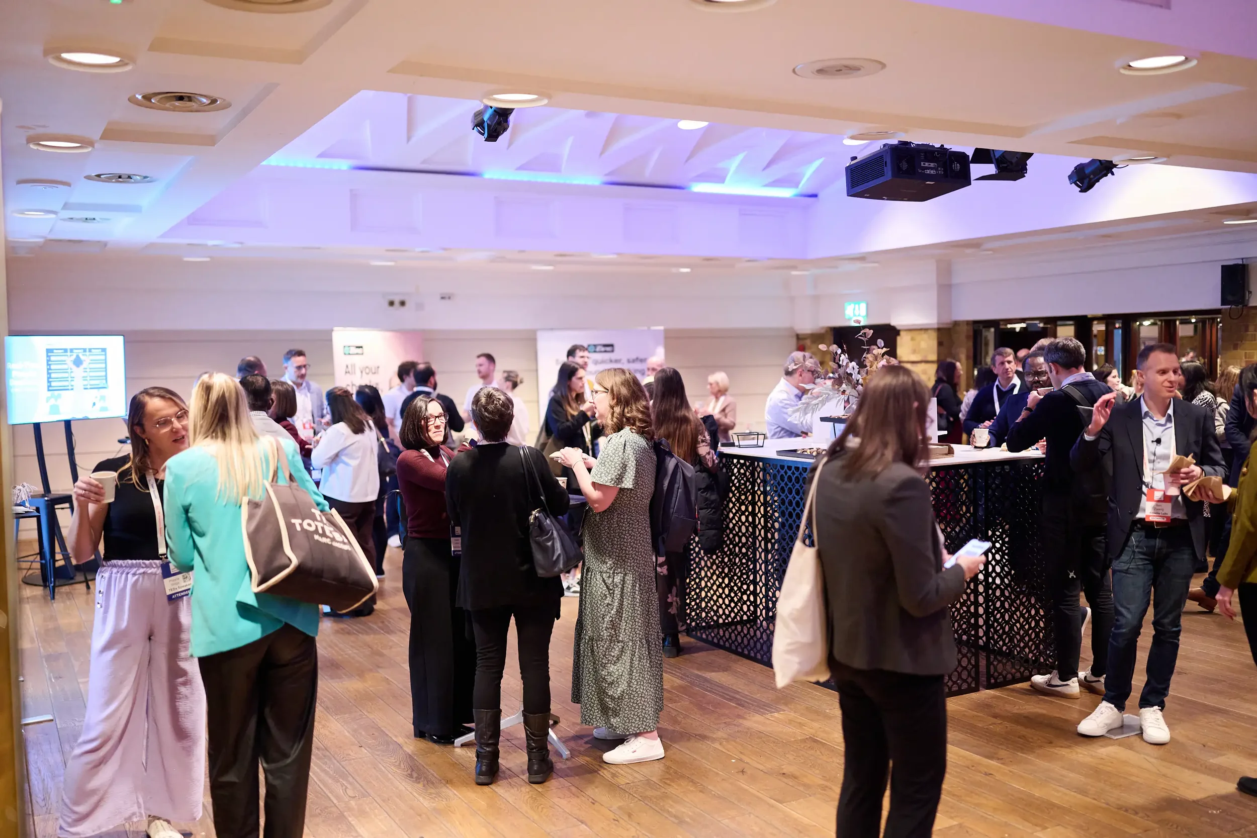 Delegates comparing approaches during a networking break at SWP Summit 2026