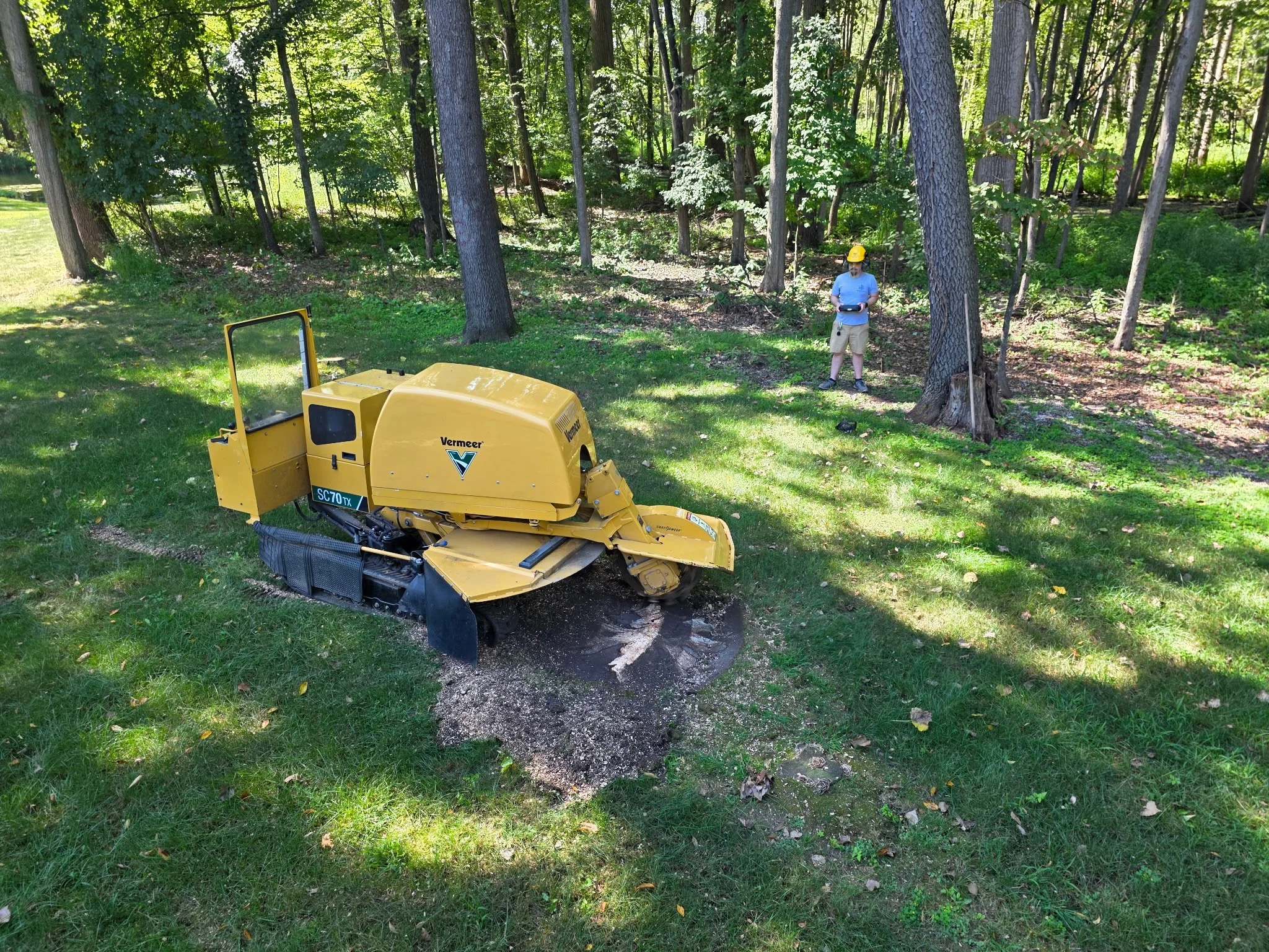 Stump grinding in progress with a Vermeer SC70TX tracked grinder at a Metro Detroit home
